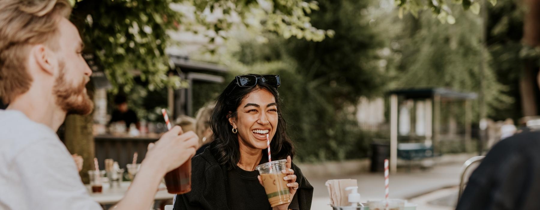 a group of people sitting at a table outside