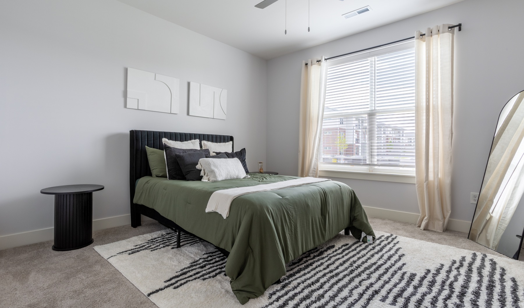 Bedroom with large windows and white walls