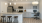 Staged apartment kitchen with island and desk