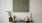 a table with a clock and a vase with flowers on it